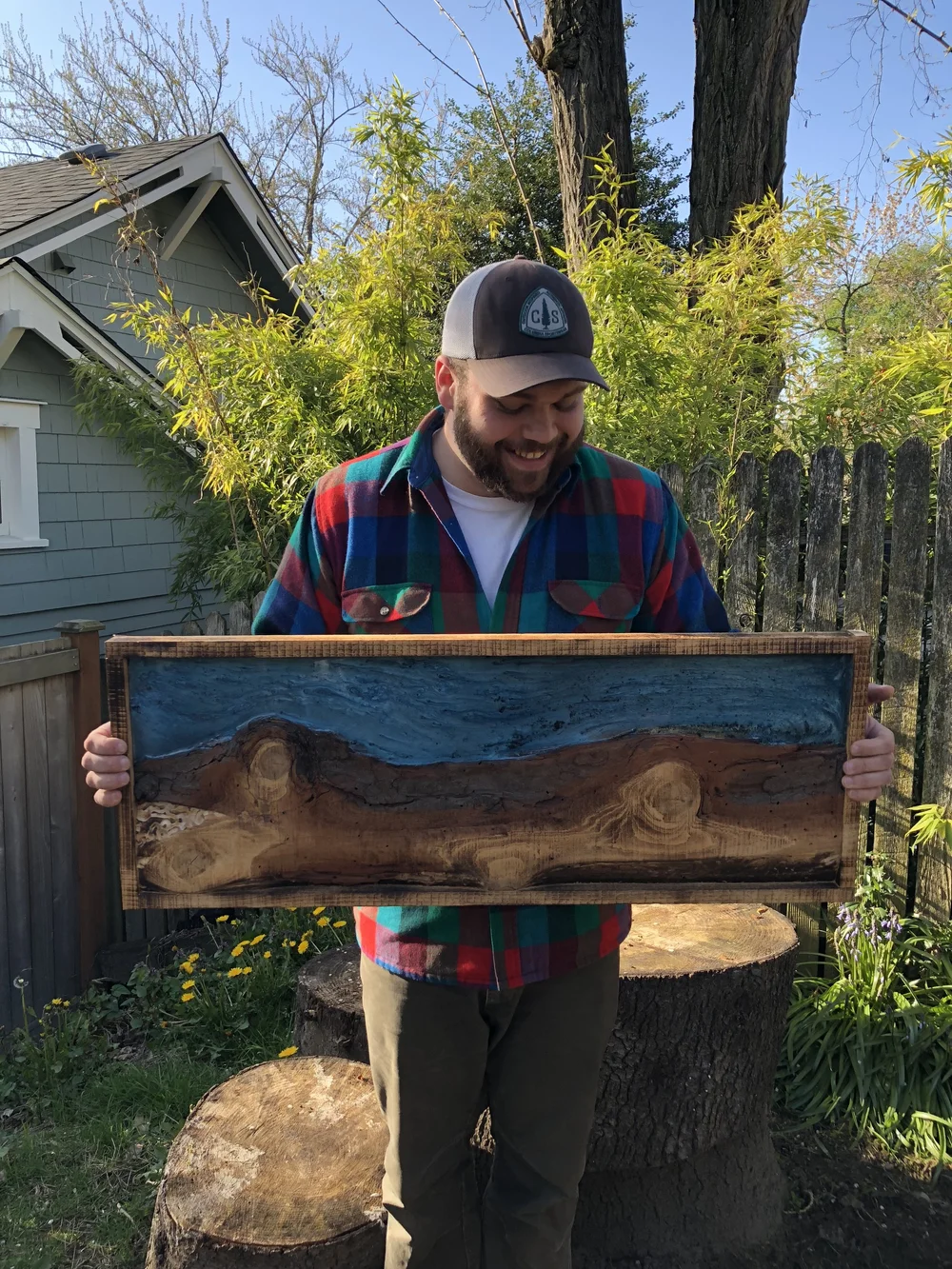 Heathrow Andrews holding a resin river art piece